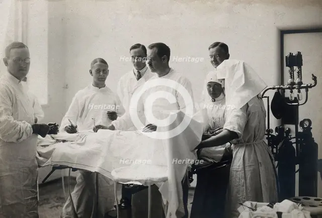 Einar Key (fourth from left), a Swedish surgeon, in an operating theatre..., c1910. Creator: Unknown.