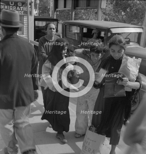 El Paso housewives after a day's shopping in Juarez, Mexico, Texas, 1937. Creator: Dorothea Lange.