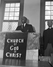 Elder Kelsey, pastor of the Church of God in Christ, opening a service..., Washington, D.C., 1942. Creator: Gordon Parks
