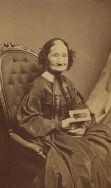Elderly woman holding a photograph, about 1865. Creator: Henry F Warren