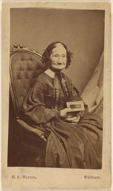 Elderly woman holding a photograph, about 1865. Creator: Henry F Warren