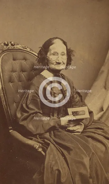 Elderly woman holding a photograph, about 1865. Creator: Henry F Warren.