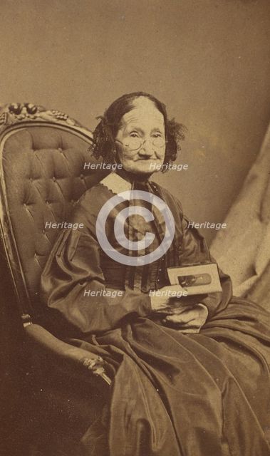 Elderly woman holding a photograph, about 1865. Creator: Henry F Warren.