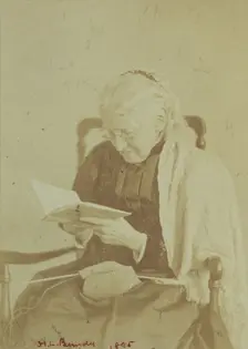 Elderly woman seated and reading a book with knitting in her lap, 1895. Creator: Horace L Bundy