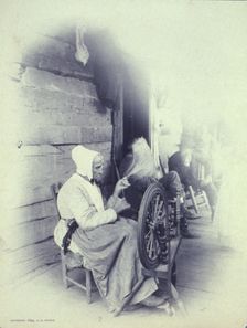 Elderly woman sitting on porch spinning, c1894. Creator: Charles Richards Dodge