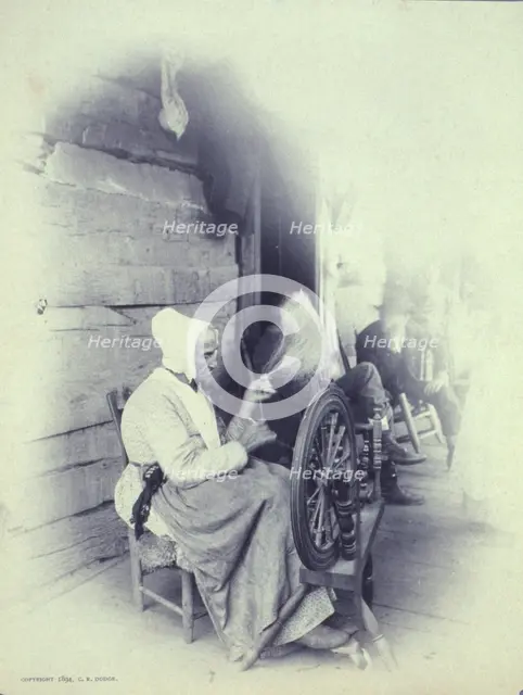 Elderly woman sitting on porch spinning, c1894. Creator: Charles Richards Dodge.