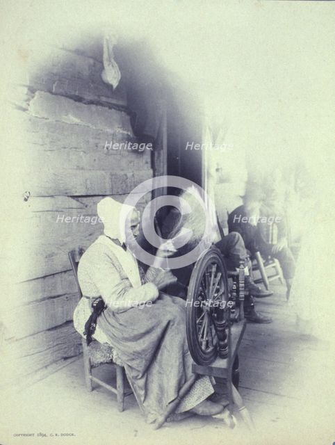 Elderly woman sitting on porch spinning, c1894. Creator: Charles Richards Dodge.