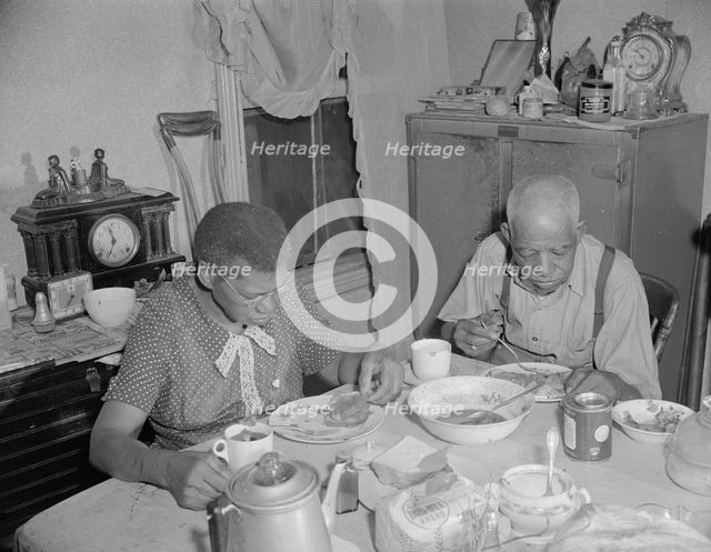 Elderly couple eating dinner at their home on Lamont Street, N.W., Washington, D.C., 1942. Creator: Gordon Parks.