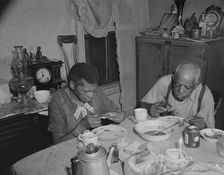 Elderly couple eating dinner at their home on Lamont Street, N.W., Washington, D.C., 1942. Creator: Gordon Parks
