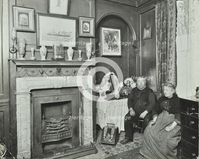 Elderly couple in Victorian interior, Albury Street, Deptford, London, 1911. Artist: Unknown.