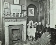 Elderly couple in Victorian interior, Albury Street, Deptford, London, 1911