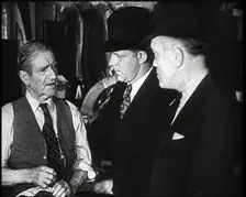 Elderly Male Civilian Being Threatened For Protection Money By Two Male Civilians, 1932. Creator: British Pathe Ltd