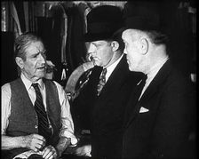 Elderly Male Civilian Being Threatened For Protection Money By Two Male Civilians, 1932. Creator: British Pathe Ltd