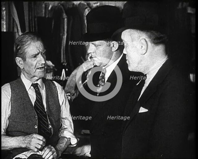 Elderly Male Civilian Being Threatened For Protection Money By Two Male Civilians, 1932. Creator: British Pathe Ltd.