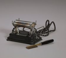 Electrical hot comb heater and hot comb, 1920s. Creator: Unknown