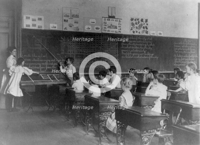 Elementary school children studying map of city, Washington, D.C., (1899?). Creator: Frances Benjamin Johnston.