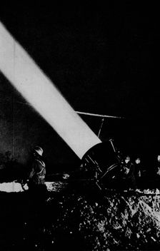 Elephant's child. A searchlight of 210,000,000 candle-power probes the night sky with its beam, 1