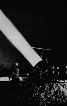 Elephant's child. A searchlight of 210,000,000 candle-power probes the night sky with its beam, 1