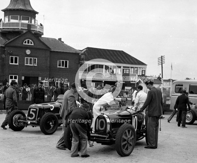 ERA and Charles Mortimer's Bugatti Type 35B at Brooklands, Surrey, 1939. Artist: Bill Brunell.