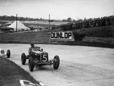ERA and Maserati taking a corner in a race at Brooklands. Artist: Bill Brunell