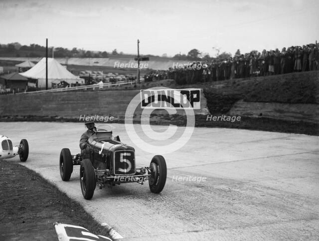 ERA and Maserati taking a corner in a race at Brooklands. Artist: Bill Brunell.