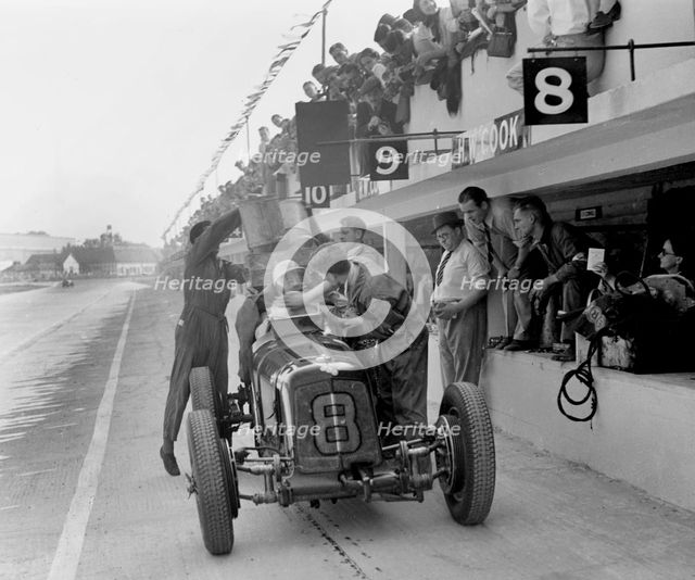 ERA R4C of Raymond Mays refuelling in the pits, JCC International Trophy, Brooklands, Surrey, 1937. Artist: Bill Brunell.