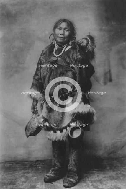 Eskimo mother carrying a child on her back, 1916(?). Creator: Unknown.