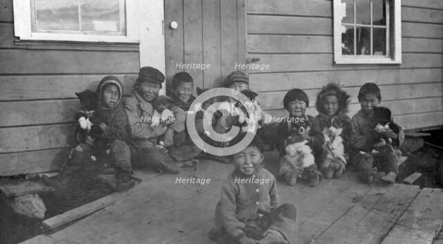 Eskimo children and puppies at the Moravian Mission Station, between c1900 and c1930. Creator: Unknown.