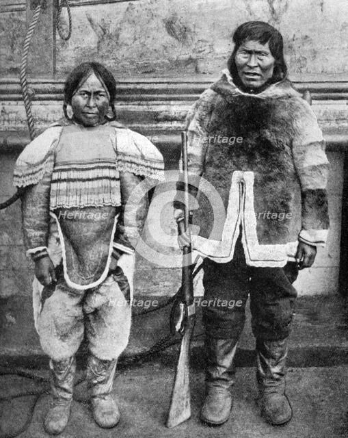 Eskimo hunter and his wife in winter costume, c1922. Artist: Brown Bros