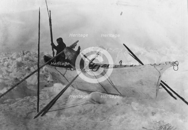 Eskimo in boat made with skins called an umiak, between c1900 and c1930. Creator: Unknown.