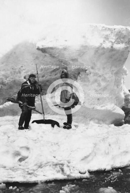 Eskimo with another man in winter scene, between c1900 and 1927. Creator: Lomen Brothers.