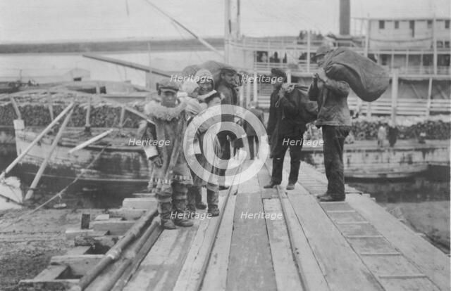 Eskimos on a dock, between c1900 and 1916. Creator: Unknown.