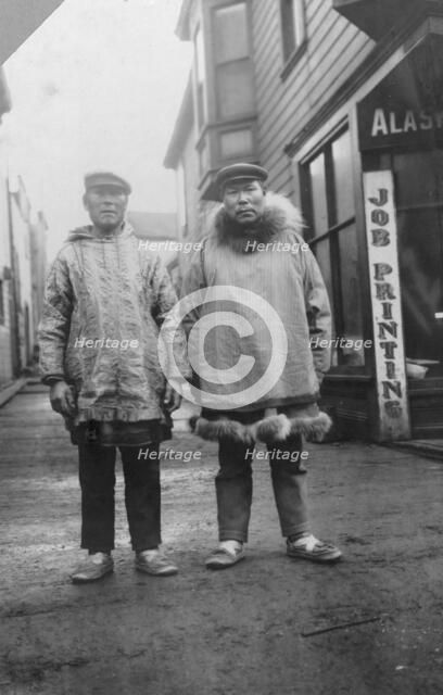 Eskimos outside shops, on a commercial street in Nome, between c1900 and 1916. Creator: Unknown.
