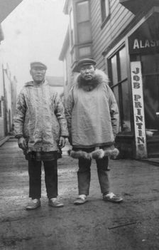 Eskimos outside shops, on a commercial street in Nome, between c1900 and 1916. Creator: Unknown