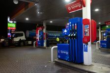 Esso petrol station forecourt with tanker delivering fuel, 2020. Creator: Tim Woodcock