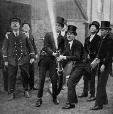 Eton's amateur firemen practising a hose drill, Berkshire, c1922