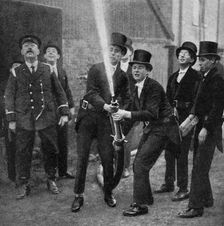 Eton's amateur firemen practising a hose drill, Berkshire, c1922