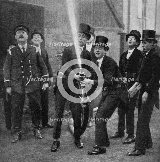 Eton's amateur firemen practising a hose drill, Berkshire, c1922. Artist: Unknown