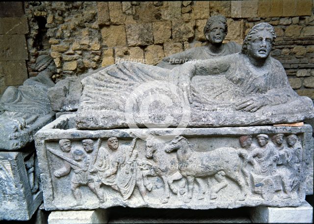 Etruscan stone sarcophagus with reliefs of Eastern influence, with a sculpture of a woman lying o…