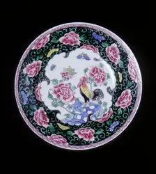 European copy of a Chinese famille noire plate with cockerel looking at a butterfly, 20th century. Creator: Unknown