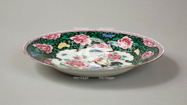 European copy of famille noire plate with cockerel looking at a butterfly, 20th century. Artist: Unknown.