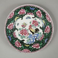 European copy of famille noire plate with cockerel looking at a butterfly, 20th century