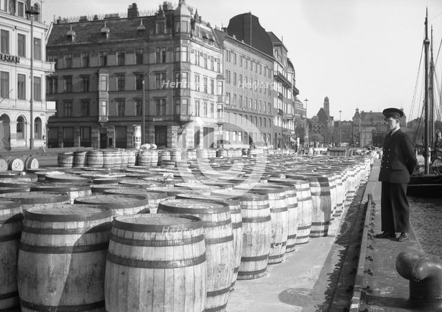 Evaporated milk in barrels for export on the quayside, Malmö, Sweden, May 1947. Creator: Otto Ohm.