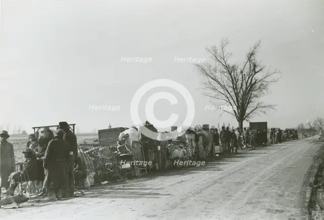 Evicted African American sharecroppers standing with their belongings along Highway 60..., Jan 1939. Creators: Farm Security Administration, Arthur Rothstein.