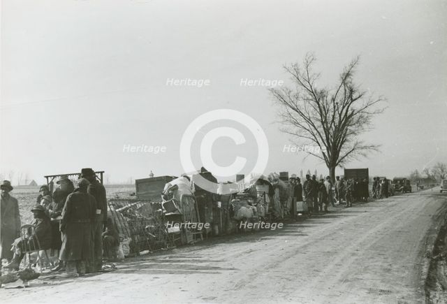 Evicted African American sharecroppers standing with their belongings along Highway 60..., Jan 1939. Creators: Farm Security Administration, Arthur Rothstein.
