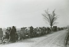 Evicted African American sharecroppers standing with their belongings along Highway 60..., Jan 1939. Creators: Farm Security Administration, Arthur Rothstein
