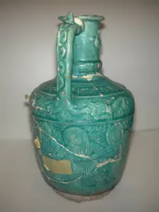 Ewer with Molded Inscriptions, Animals and Dancers, Iran, last quarter 11th or 12th century. Creator: Abu Ahmad Qassai