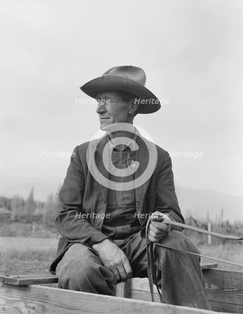 Ex-Nebraska farmer now developing farm out of the stumps, Bonner County, Idaho, 1939. Creator: Dorothea Lange.