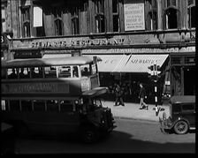 Exterior of Stewards Restaurant and London Traffic. Sign on the Side of a Bus Reads..., 1931. Creator: British Pathe Ltd