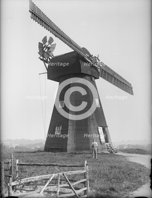 Exterior of the Old Mill, Northbourne, Kent with the miller, Mr J Court, stood outside, 1933. Creator: HES Simmons.